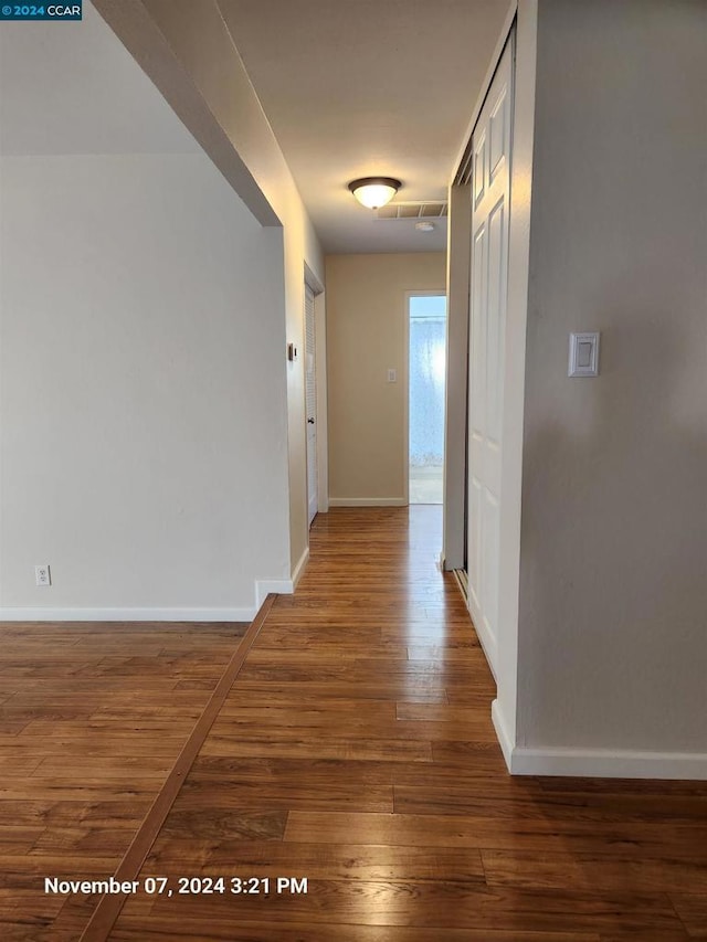 hallway featuring dark wood-type flooring