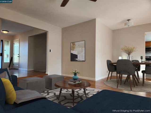 living room with ceiling fan and light wood-type flooring