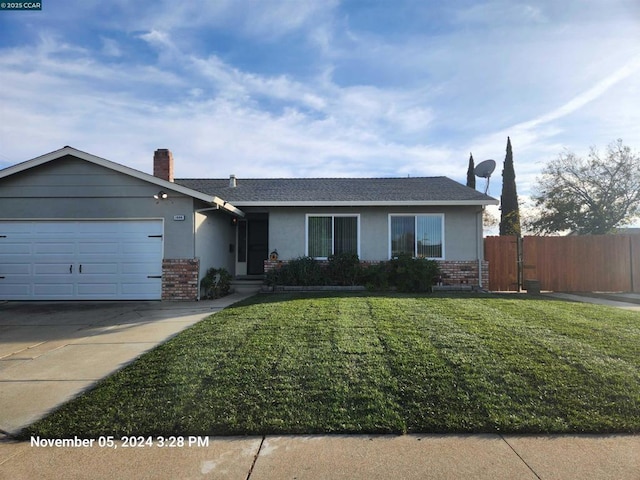 ranch-style home with a garage and a front lawn