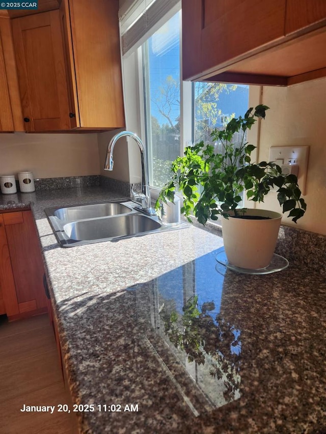 kitchen featuring sink and dark stone counters