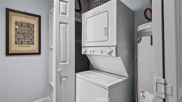 clothes washing area featuring stacked washer / drying machine