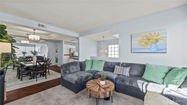 living room featuring a chandelier and hardwood / wood-style floors