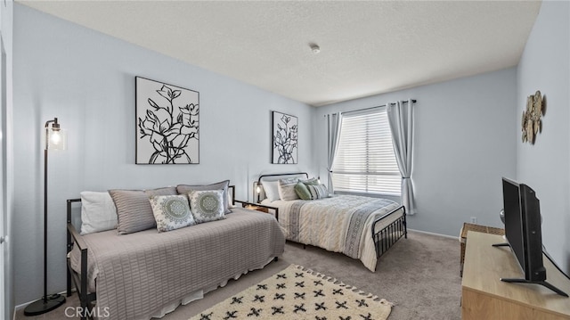 carpeted bedroom featuring a textured ceiling