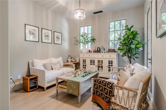 sitting room featuring an inviting chandelier and light wood-type flooring