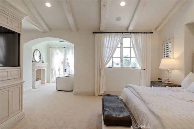 carpeted bedroom featuring beamed ceiling