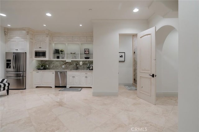 kitchen with decorative backsplash, sink, and stainless steel appliances