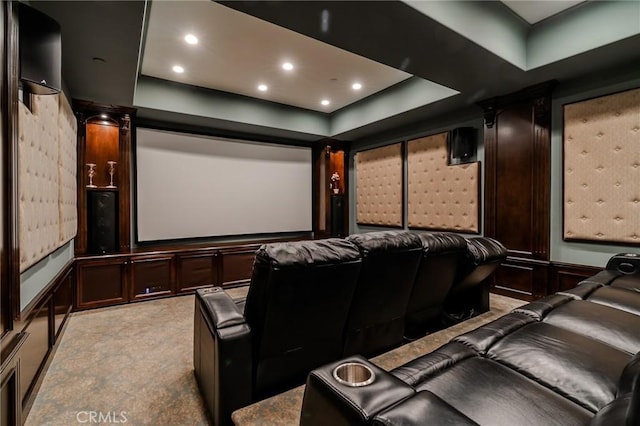 home theater room featuring a raised ceiling