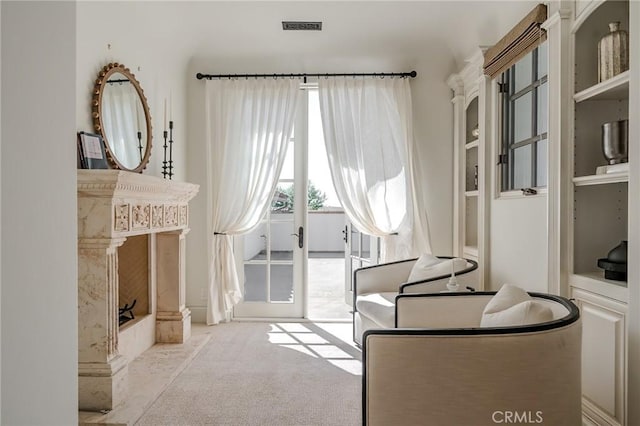 living area with light carpet and french doors