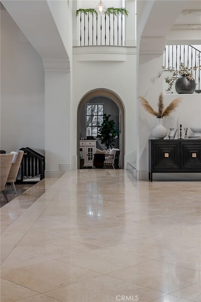 foyer entrance with a wealth of natural light and a high ceiling