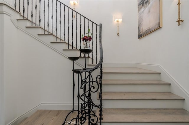 stairs with hardwood / wood-style flooring