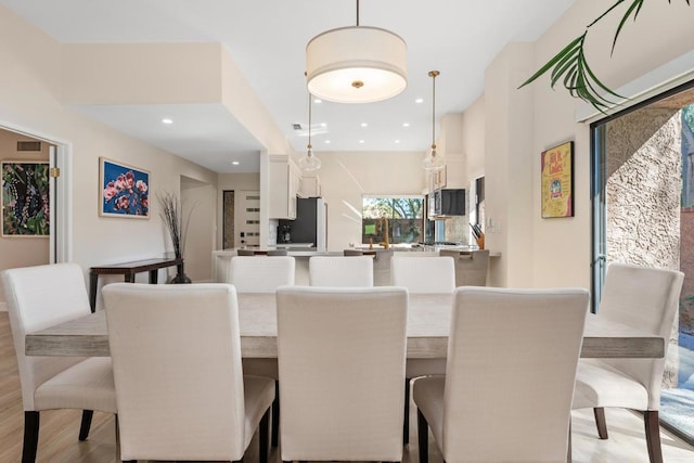 dining area with light hardwood / wood-style floors