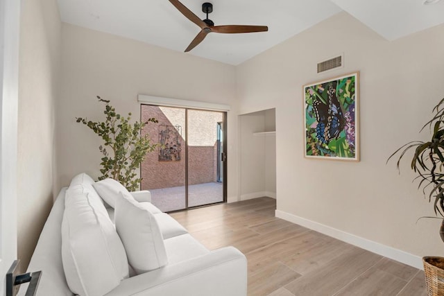 living room featuring ceiling fan and light hardwood / wood-style floors