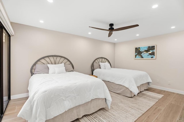 bedroom featuring ceiling fan and light hardwood / wood-style flooring