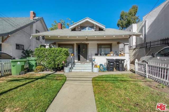 bungalow-style house with a porch and a front yard