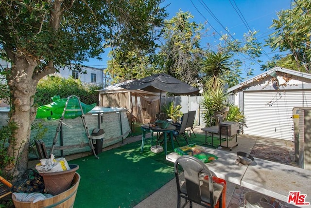 view of patio with an outbuilding