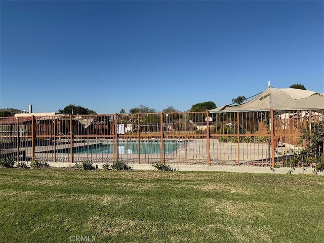 view of pool with a yard