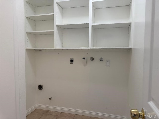 washroom featuring gas dryer hookup, electric dryer hookup, hookup for a washing machine, and light tile patterned floors