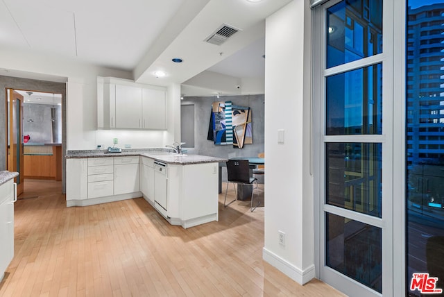 kitchen with kitchen peninsula, white cabinetry, white dishwasher, and light hardwood / wood-style floors