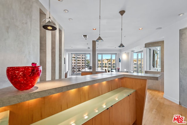 kitchen featuring pendant lighting and light hardwood / wood-style flooring