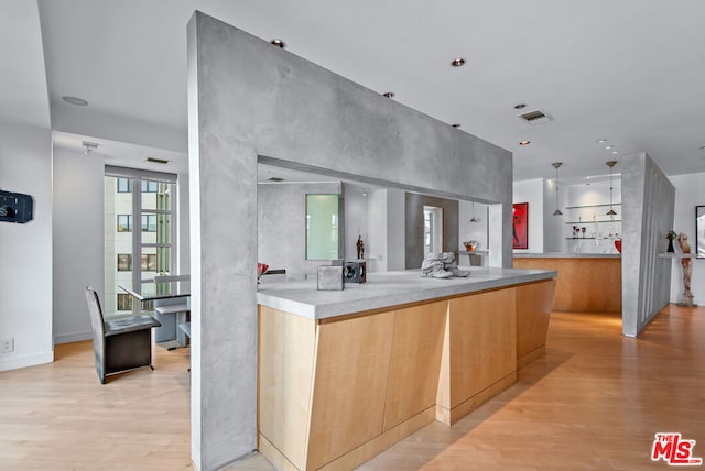 kitchen featuring light brown cabinetry and light wood-type flooring