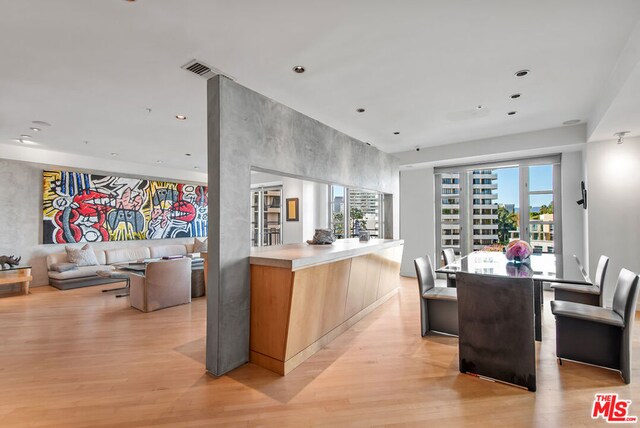 kitchen featuring a center island, light wood-type flooring, and a wealth of natural light