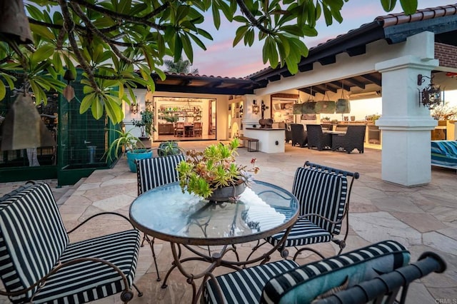 patio terrace at dusk with exterior kitchen