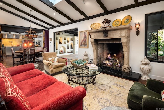 living room featuring vaulted ceiling with beams and a high end fireplace