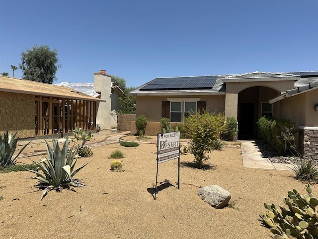 rear view of house with solar panels