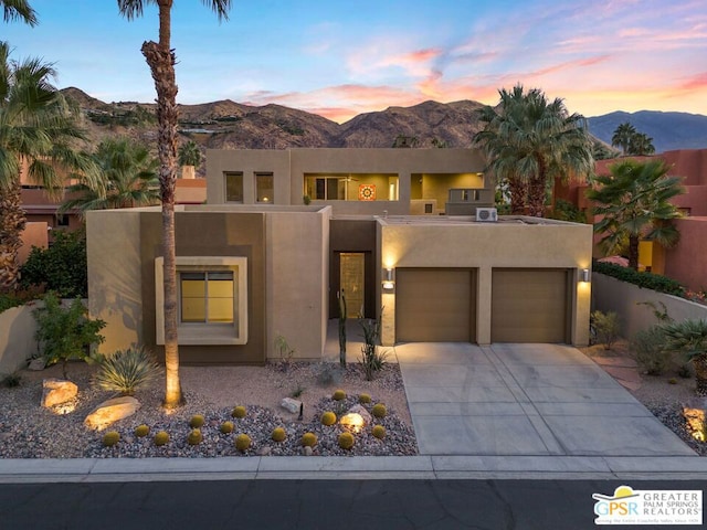 pueblo revival-style home with a mountain view and a garage