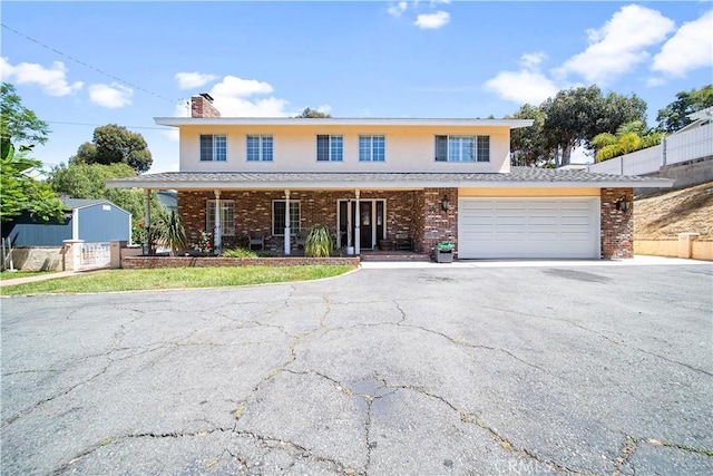 front facade featuring a garage and covered porch