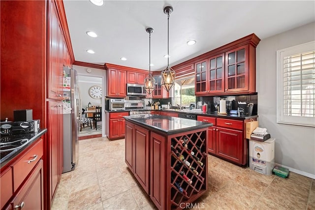 kitchen with appliances with stainless steel finishes, tasteful backsplash, crown molding, a kitchen island, and hanging light fixtures