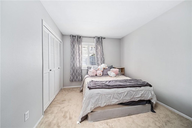 bedroom with light colored carpet and a closet