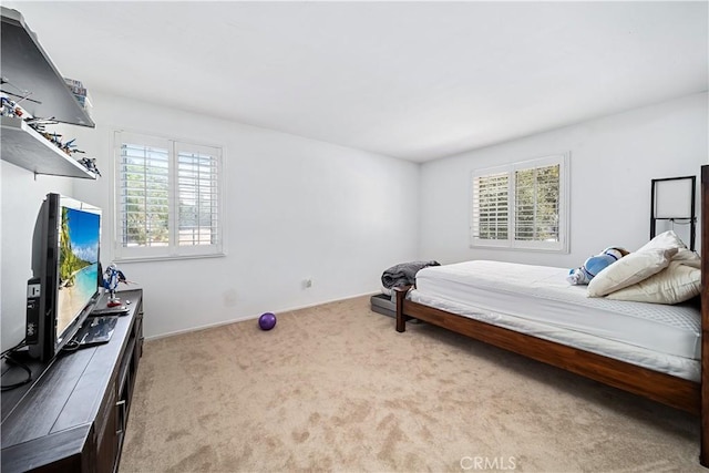 carpeted bedroom with multiple windows