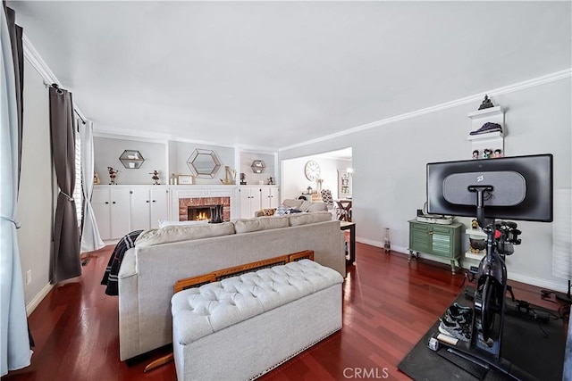 bedroom with a fireplace, dark wood-type flooring, and ornamental molding