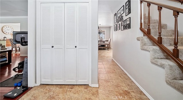 hall with crown molding and light tile patterned flooring