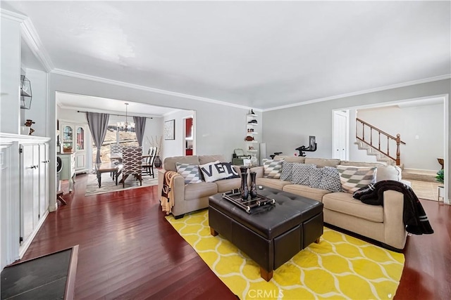 living room with crown molding, hardwood / wood-style floors, and a notable chandelier