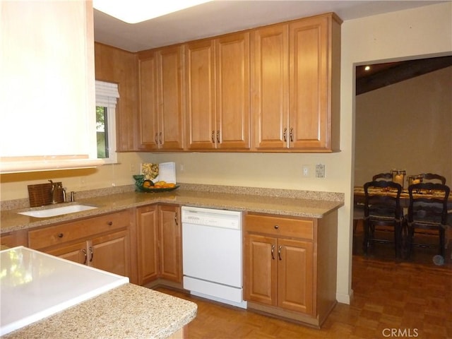 kitchen featuring parquet floors, light stone countertops, sink, and white dishwasher