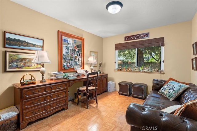 office space with built in desk and light parquet flooring