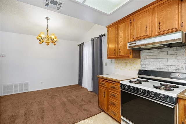 kitchen with pendant lighting, white range with gas cooktop, a chandelier, vaulted ceiling, and light colored carpet