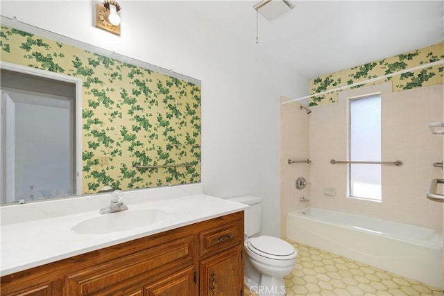 bathroom with shower / washtub combination, wallpapered walls, toilet, and vanity