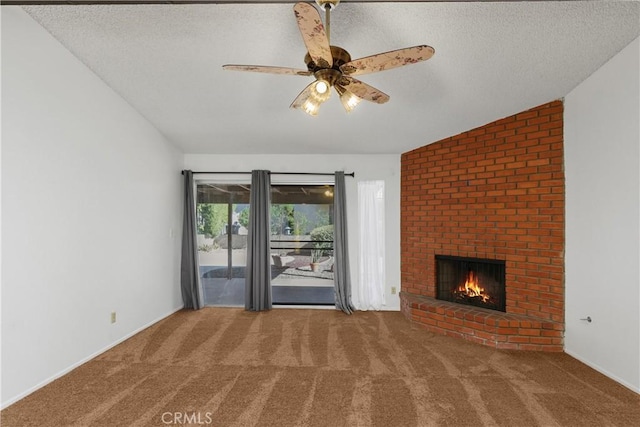 unfurnished living room featuring a textured ceiling, carpet, vaulted ceiling, and a fireplace