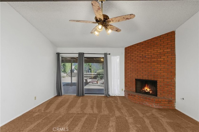unfurnished living room featuring carpet flooring, a brick fireplace, ceiling fan, and a textured ceiling