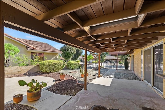 view of patio with a gate and fence