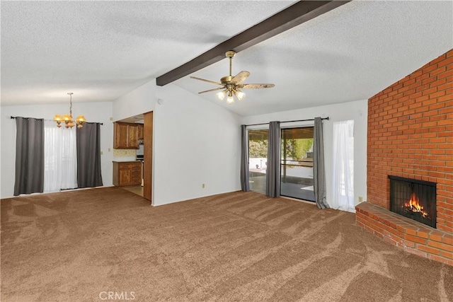 unfurnished living room with carpet flooring, lofted ceiling with beams, ceiling fan with notable chandelier, a textured ceiling, and a fireplace