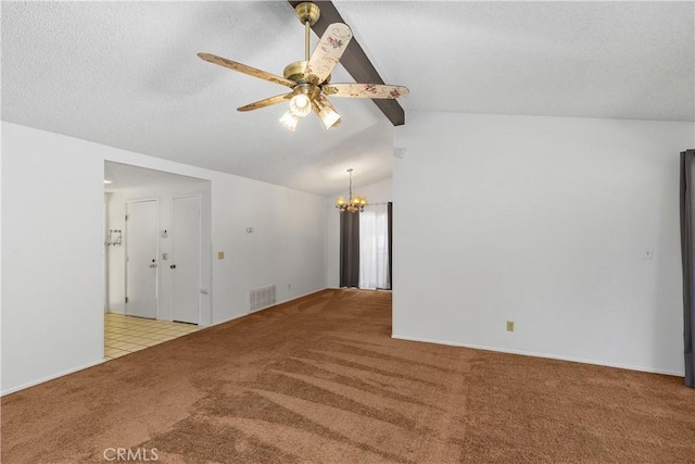 spare room with lofted ceiling with beams, ceiling fan with notable chandelier, a textured ceiling, carpet floors, and visible vents