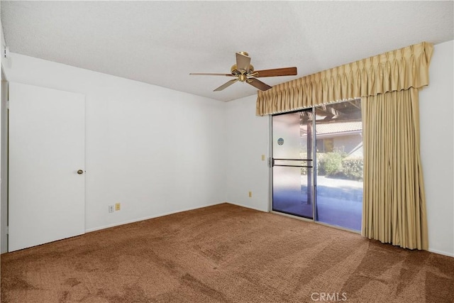 carpeted empty room with ceiling fan and a textured ceiling