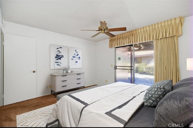 bedroom with access to exterior, a ceiling fan, carpet floors, and a textured ceiling
