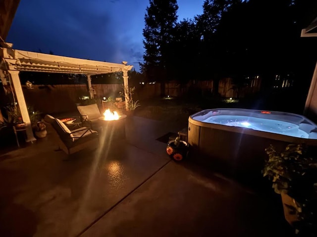 view of patio featuring an outdoor fire pit and a hot tub