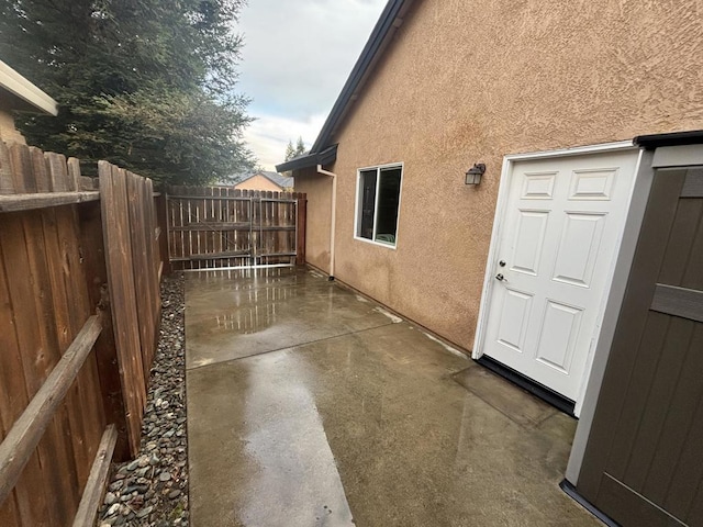 view of side of home with a patio