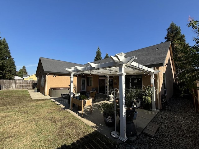 back of house with a patio area, a pergola, a yard, and a hot tub